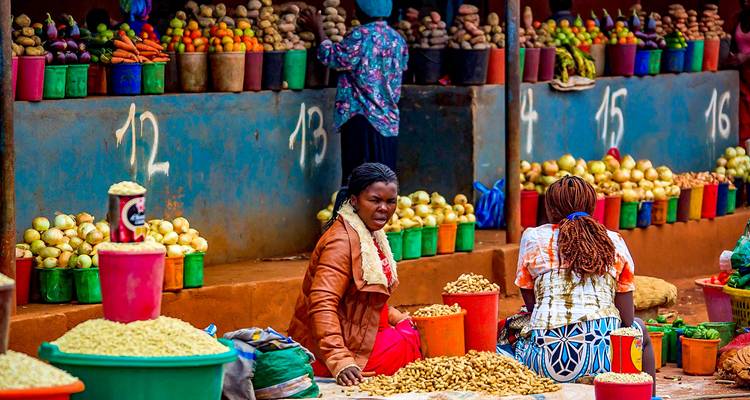 Lively market scene with people and colorful produce.
