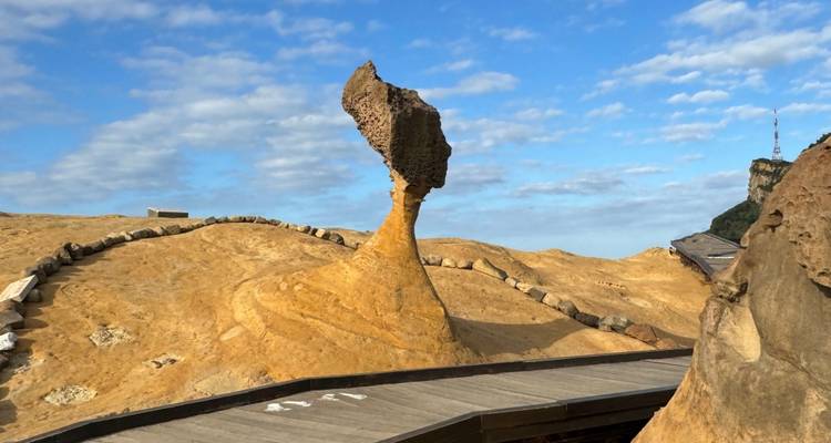 Striking rock formation in a park under a blue sky.