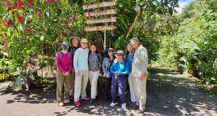 A group of people standing in front of a nature reserve entrance.