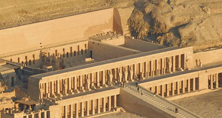 Aerial view of an ancient stone temple complex in a desert setting.