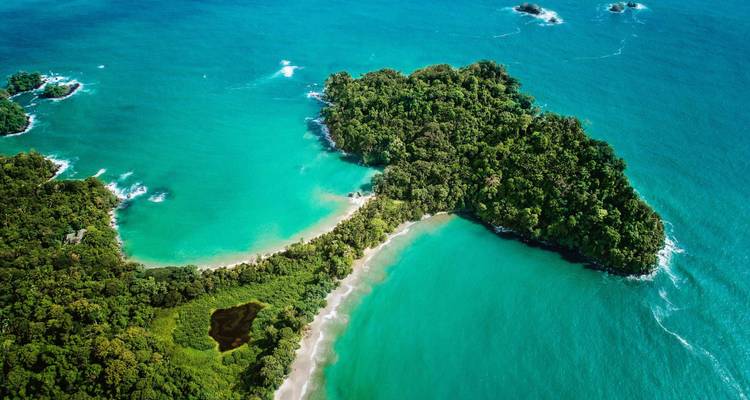 A stunning aerial view of a tropical island with two beaches.