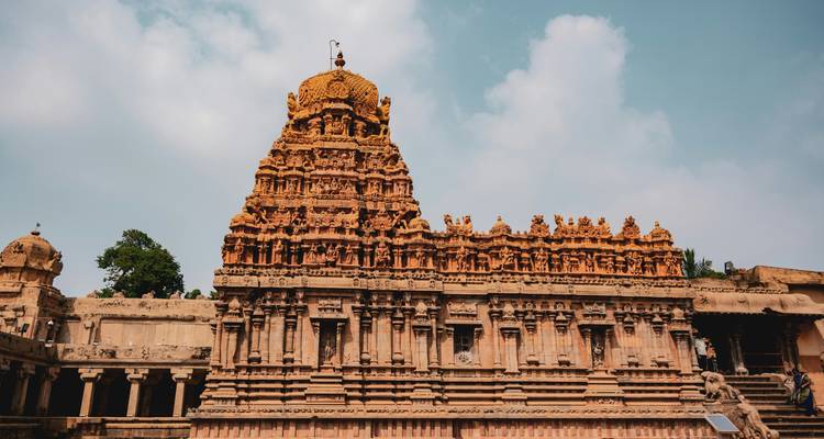 Detail of temple tower with intricate carvings and decorative elements.