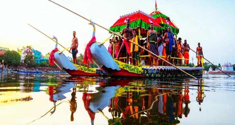 Colorful traditional boat with people on a river.