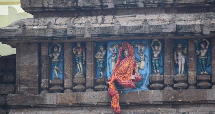 Decorated wall with detailed sculptures and a piece of cloth.