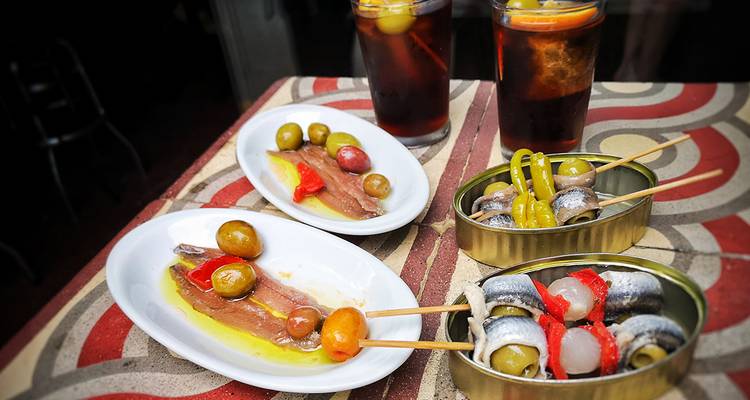 Traditional tapas with drinks on a table.
