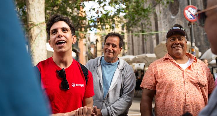 Group of people talking with an outdoor background.