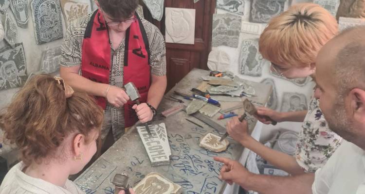 Des personnes travaillant sur de l'artisanat dans un atelier avec des objets en pierre.