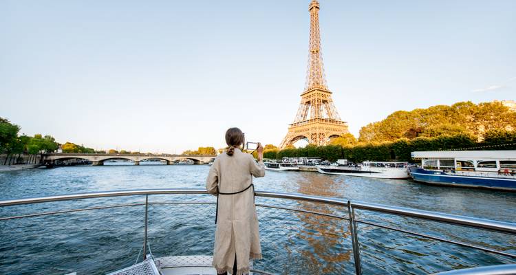 Person on a boat taking a photo of the Eiffel Tower.