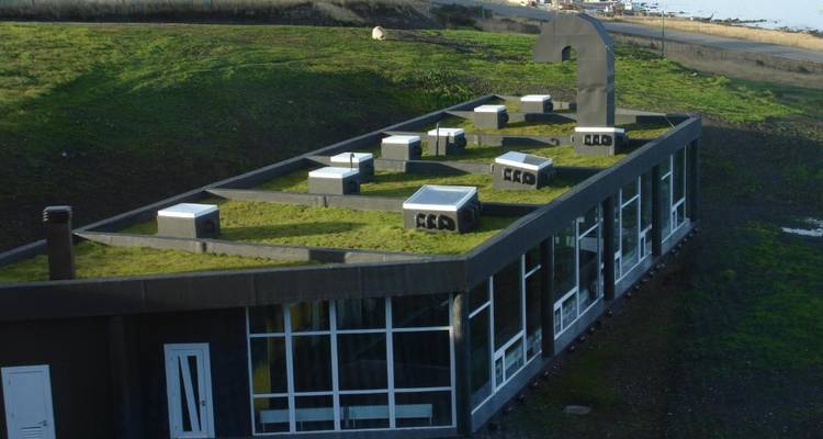 A green-roofed building in a scenic location.