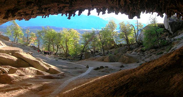 Cave entrance with a view of trees and a pathway.