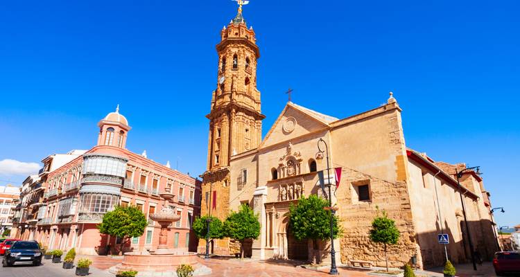 Historic church and buildings with clear blue sky.