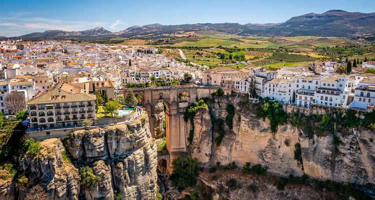 Aerial view of the iconic cliffside town with bridge and buildings.
