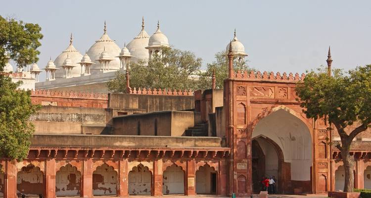 Historic red stone courtyard with domed structures.