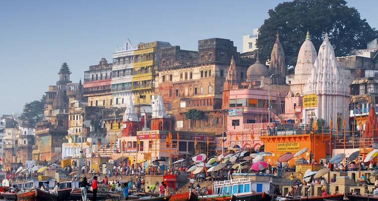 Bustling riverside city with vibrant buildings and boats.