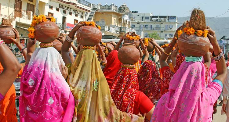 Colorful street procession with people wearing vibrant attire.