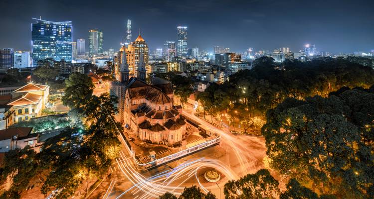 Nightscape of a city with light trails and buildings.