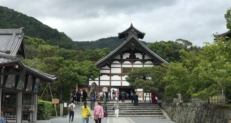 A group of people outside a traditional Japanese building.