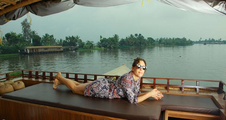 Femme se relaxant sur une péniche dans les backwaters.
