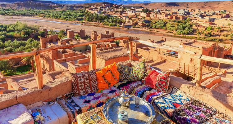 Rooftop view over a rural village beside a river.