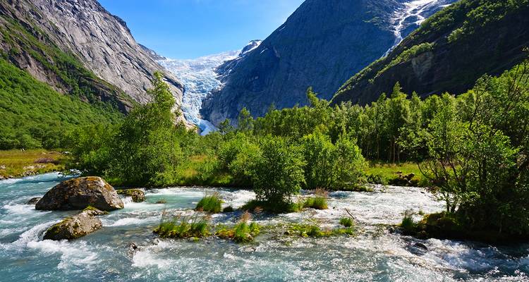 Glacier-fed river flowing through a lush valley.
