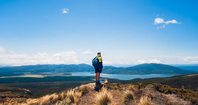 Randonneur contemplant un paysage pittoresque avec un lac