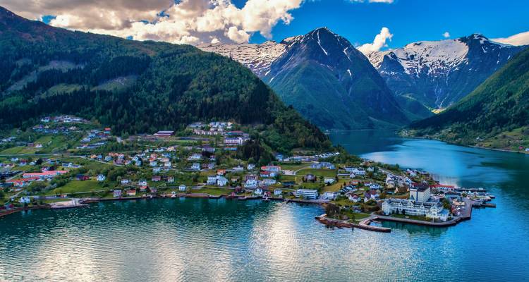 Quaint coastal town nestled between mountains and a fjord.