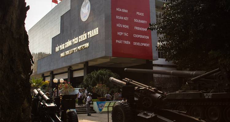 Museum facade with warfare exhibits displayed outside, located in Ho Chi Minh City.