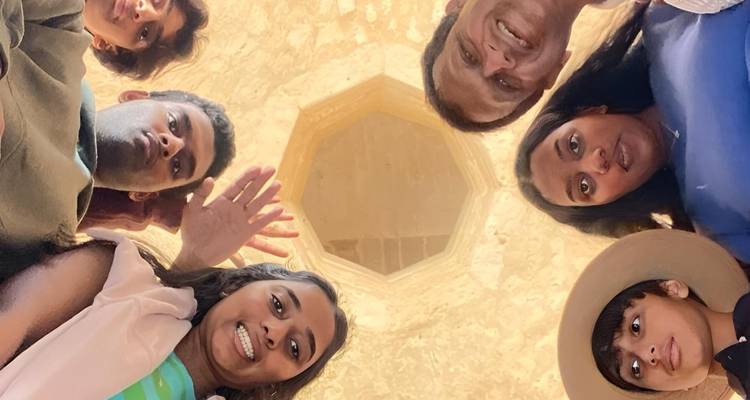 Group of people looking up inside a circular building.