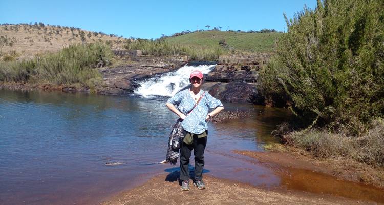 Person standing in front of a small waterfall