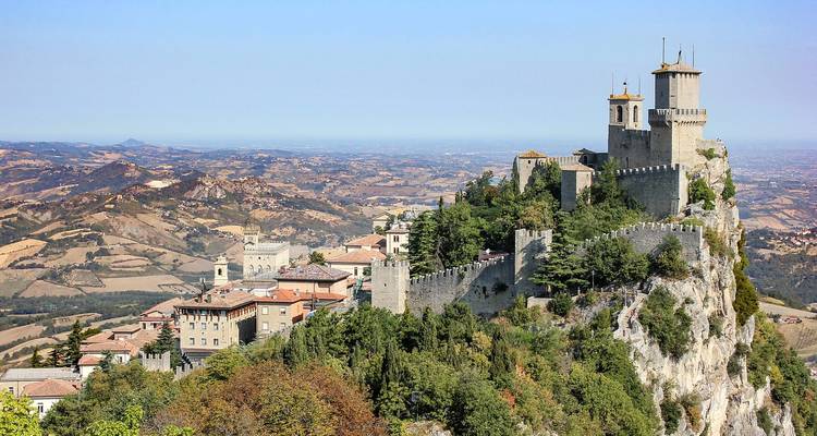 Castle on a hill overlooking a vast landscape.