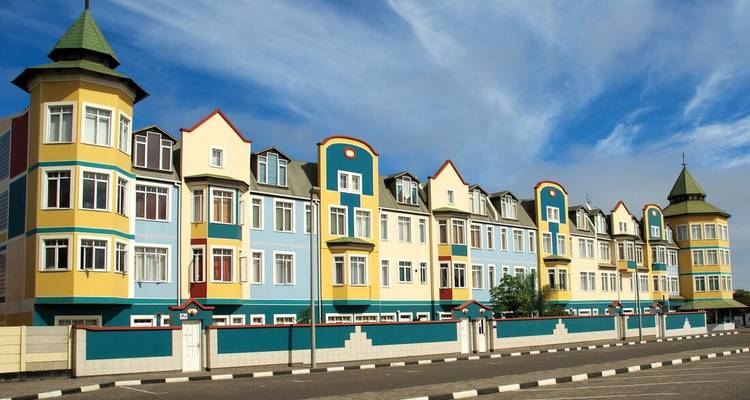 Colorful row houses under a blue sky.