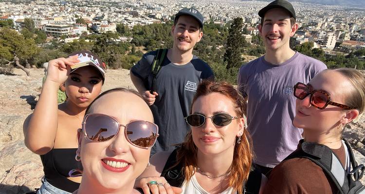 Group of people with a city view in the background.