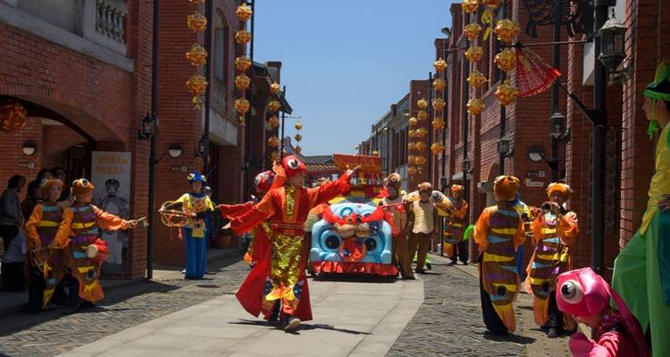 A lively street scene with traditional performers in colorful costumes.