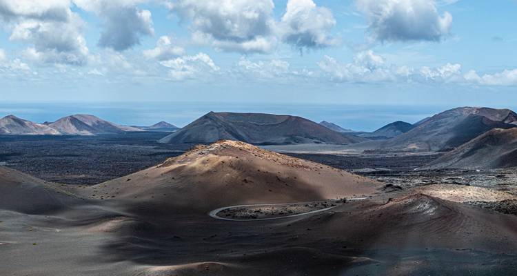 Rocky desert landscape with distant mountains.