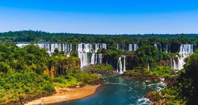 Aerial view of Iguazu Falls in lush surroundings.