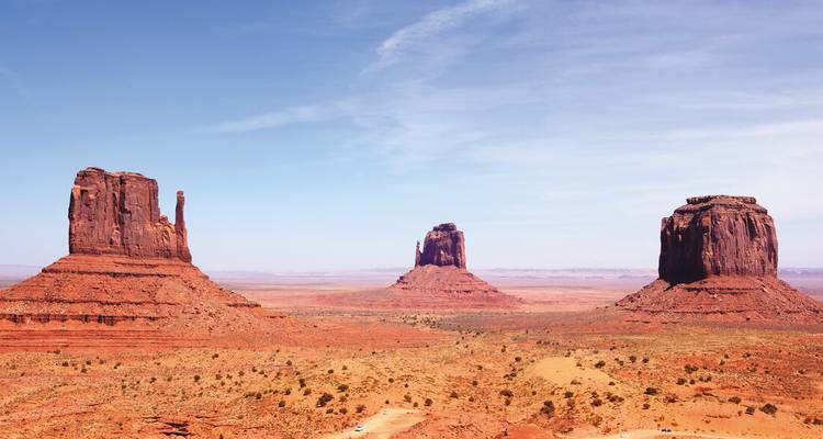 Iconic butte formations of Monument Valley under a clear sky.