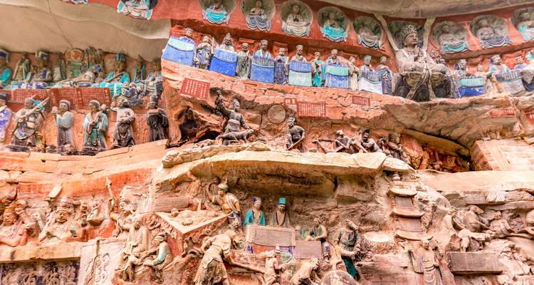 Intricate rock carvings and sculptures on a cliff face.