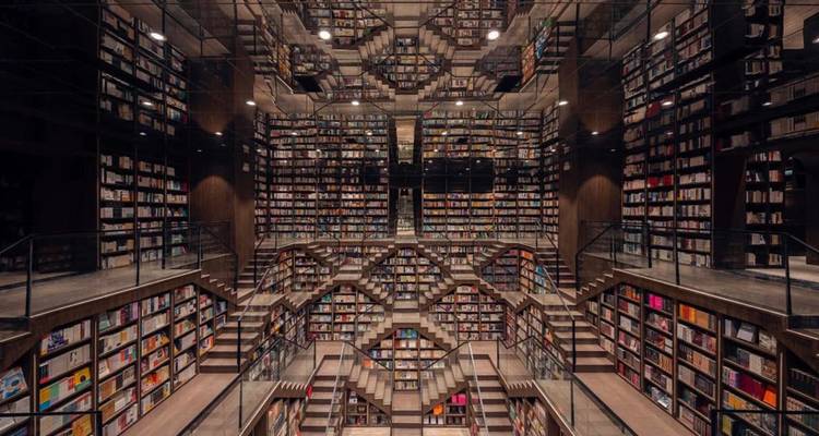 Interior of a large, modern library with mirrors.