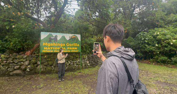 Person taking a photo of Mgahinga Gorilla National Park sign.