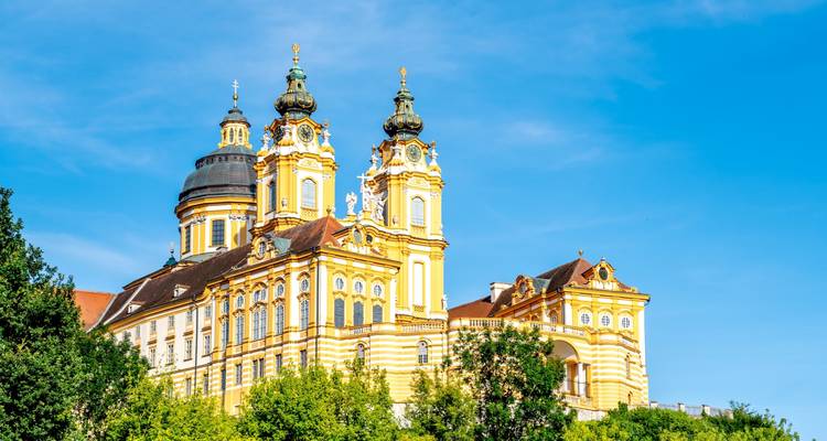 Baroque monastery with vibrant architecture and blue sky.