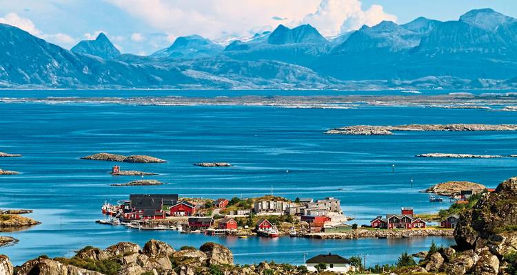 Vista panorámica de pequeñas islas con montañas al fondo.