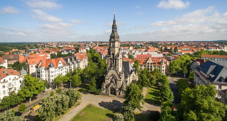 Aerial view of a historic church surrounded by a town.