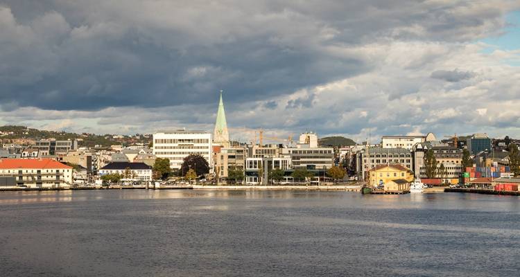 Distant view of Flensburg with a church spire and urban landscape.