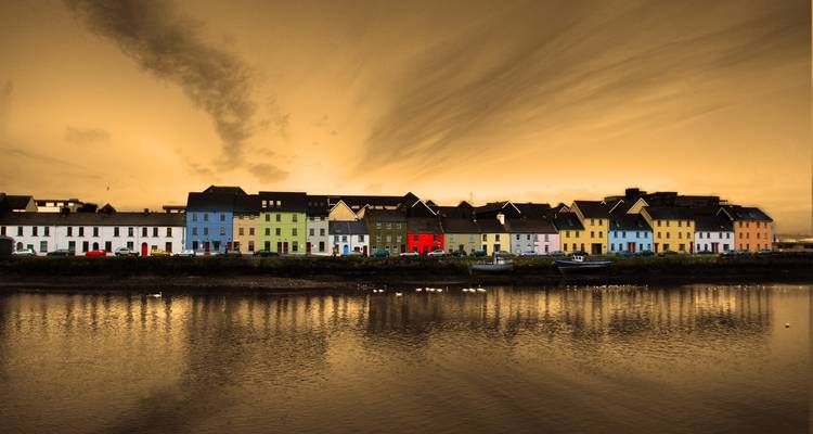 Colorful row of houses at night.