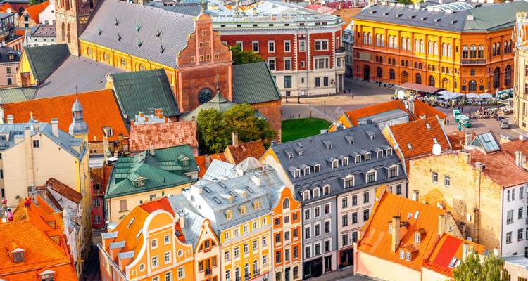Colorful buildings in a European city with a busy street.