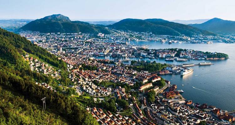 Scenic view of a coastal city with mountains in the background.