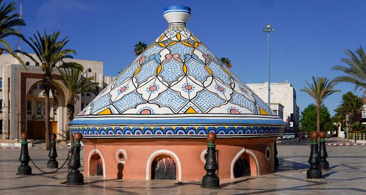 Large taajine pot-shaped structure in a public square.