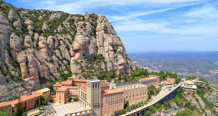 Mountain monastery with a clear sky and expansive view of the landscape.