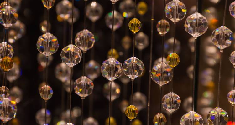 Close-up of hanging crystal decorations with various reflections.