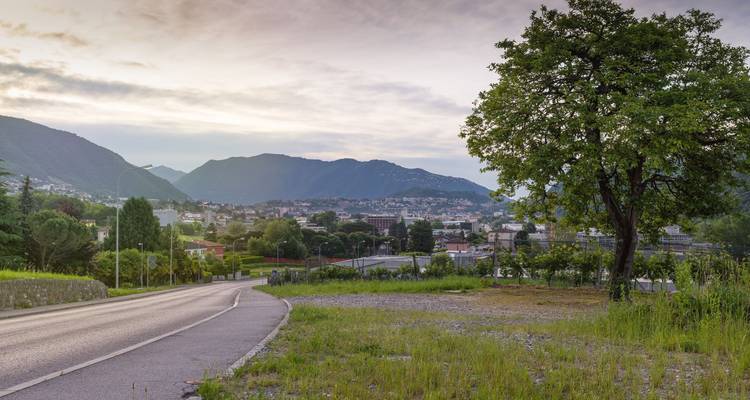 Mountain view over a city under a cloudy sky.